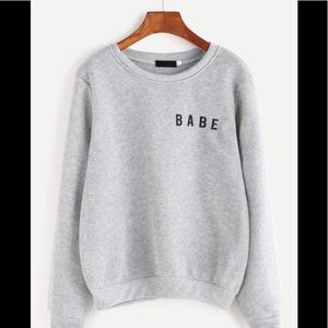 Never been worn.Light gray black lettering sweater